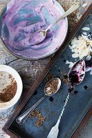 Remains of yogurt desserts with blackberry compote, cereals and flaked almonds
