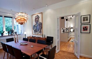 Classic Artichoke Lamp above dining table with armchairs in dining room