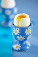 A soft-boiled egg in a flowered egg cup