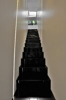 Narrow staircase with glossy black stairs