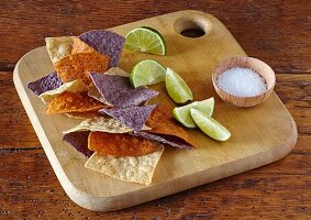 Colored tortilla chips with limes and salt