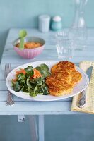 Baby food and potato cakes with salad