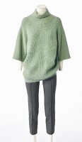 An oversized mint green knitted jumper made from merino wool and mohair and a pair of grey cigarette trousers