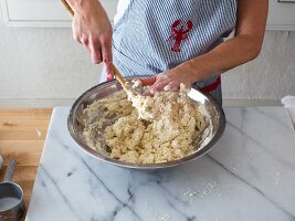 Buttermilk biscuit dough being mixed in a bowl