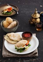 Pita bread with salmon, avocado, egg and rocket served with tomato sauce and tea