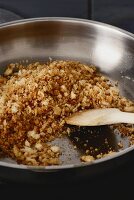 White bread crumbs being fried in butter