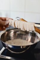 Strips of calamari tubes being floured