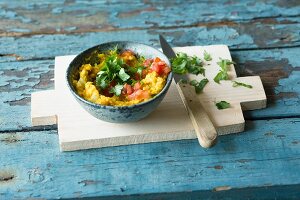 A vegan dip made from yellow lentils, tomatoes and roasted peanuts