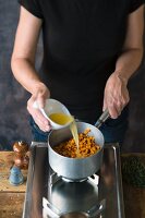 Angebratene Süßkartoffelwürfel mit Orangensaft ablöschen
