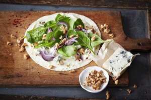 A wholemeal wrap with red onions, baby spinach, Gorgonzola and walnuts