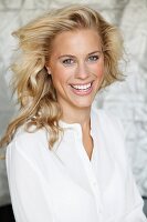 Laughing blonde woman wearing a white blouse