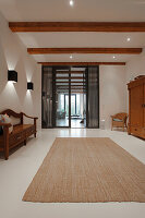 Bright living room with sisal carpet and traditional wooden furniture