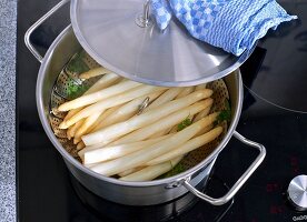 Steamed asparagus in a pot