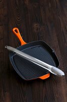 A grill pan and tongs