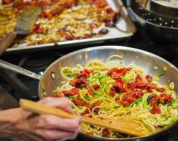 Gluten-free courgette noodles and roasted grape tomatoes in a pan