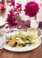 Fried salmon on a vegetable salad with avocado, asparagus and rocket