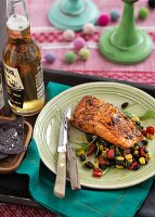 Grilled salmon on a bean salad with black tortilla chips and beer