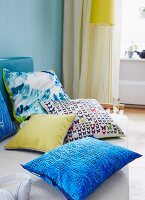 Colourful cushions with various fabrics on a sofa
