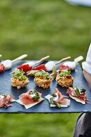 Various canapés on a slate platter