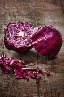 A halved red cabbage on a wooden board
