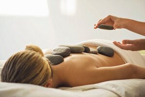 A woman having a hot stone massage