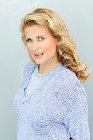 A blonde woman wearing a purple knitted jumper