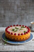 Vegan mango and papaya cake with coconut and fresh raspberries