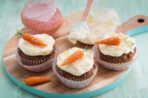 Carrot and pineapple cupcakes with marzipan decorations