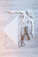 A filigree paper star being cut out