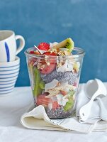 Crunchy chia seed muesli with kiwis, strawberries and grated coconut