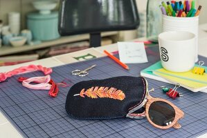 An embroidered glasses case