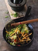 Sweet-and-sour fried potatoes in a wok