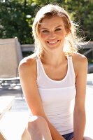 A young woman wearing a white top on a terrace