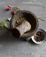 Spices being ground in a stone mortar