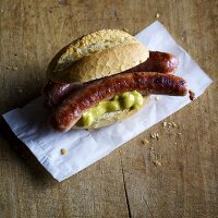 Homemade Thuringia sausages with mustard in a roll