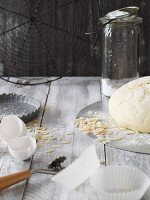 An arrangement of baking ingredients, dough and utensils