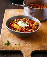 Spicy lentil and bean stew with tomatoes and sour cream