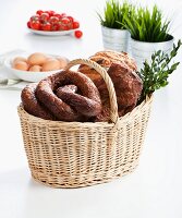 Various sausages and ham in an Easter basket