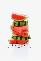 A stack of watermelon slices with seeds