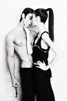 A young couple, him topless, in an intimate pose (black and white shot)