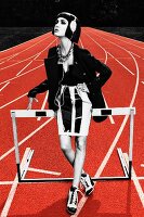 A young woman wearing a miniskirt, a corset and a blazer standing on a running track