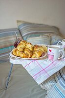 Fresh croissants with jam and coffee in a bed