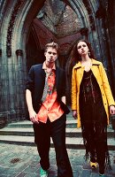 A young couple outside the doors of an old church