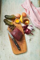 Ingredients for beef tatar: beef, gherkins, capers, onions and eggs