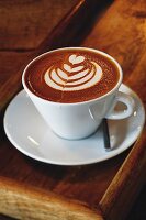 A coffee with a milk foam pattern