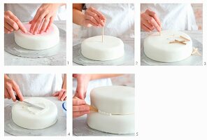 A multi-tier cake being decorated with fondant icing