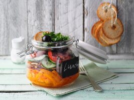 Layered spicy vegetable and bread salad in a jar