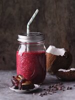 Redcurrant and date smoothie with nuts, cocoa and coconut mousse