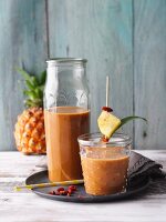 Pineapple and gojiberry smoothies with bananas, coconut mousse and maca