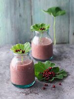 Lingonberry and fig smoothies with chia seeds, strawberries and lady's mantle leaves